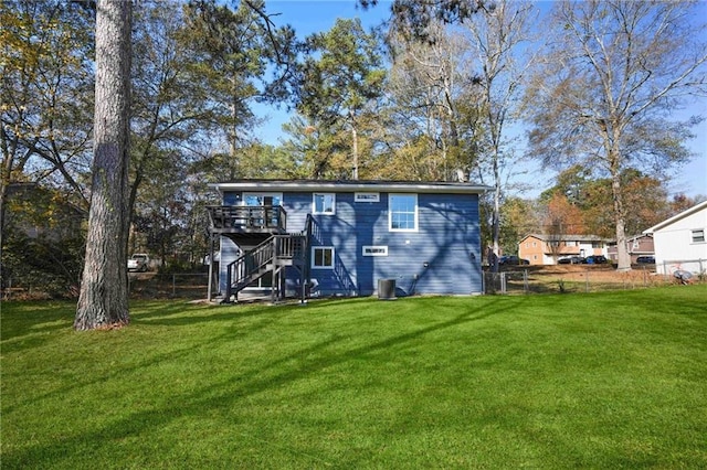 back of property with a yard and a deck