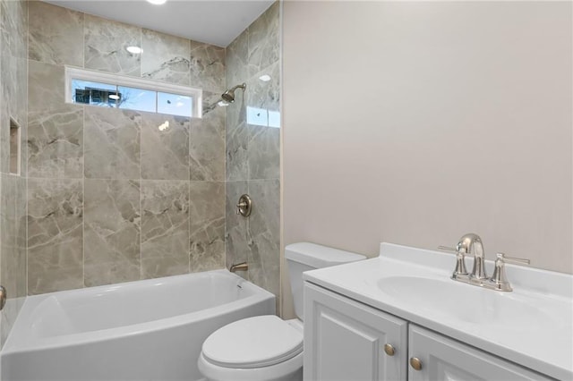 full bathroom featuring vanity, toilet, and tiled shower / bath