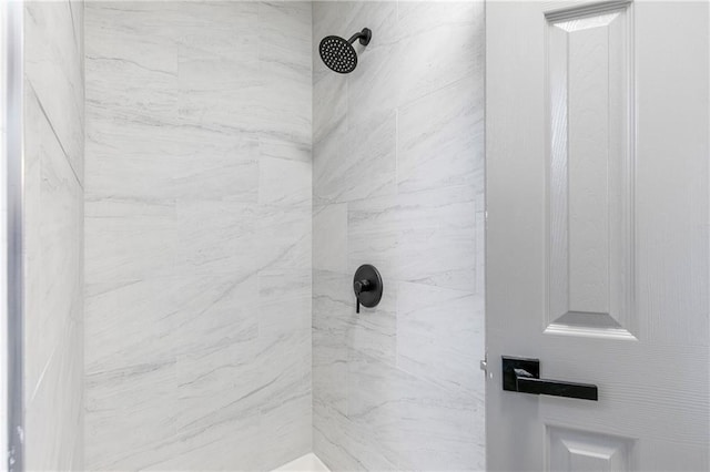 bathroom with a tile shower