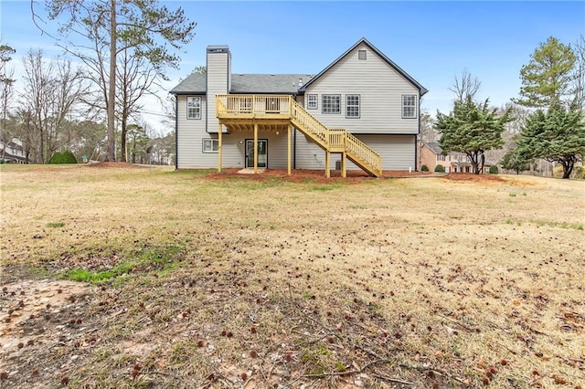 rear view of house with stairway, a chimney, a wooden deck, and a lawn