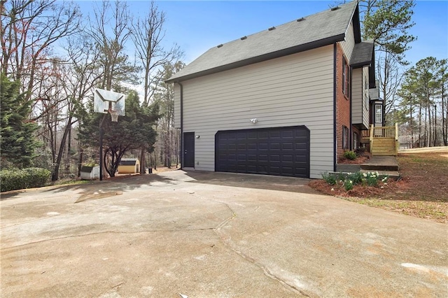 view of property exterior with concrete driveway