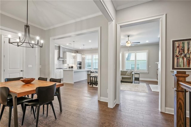 dining space with crown molding, dark hardwood / wood-style floors, and ceiling fan with notable chandelier