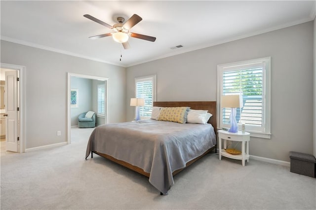 carpeted bedroom with ornamental molding and ceiling fan