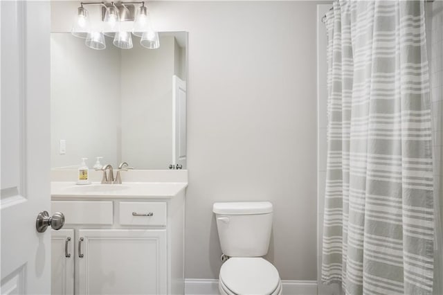 bathroom featuring vanity, curtained shower, and toilet