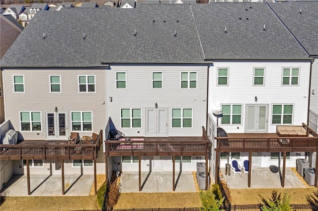 rear view of property with french doors and a patio area