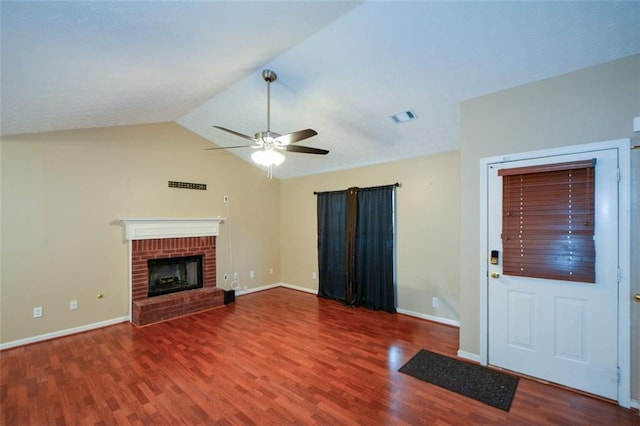 unfurnished living room with a brick fireplace, dark wood-type flooring, ceiling fan, and lofted ceiling