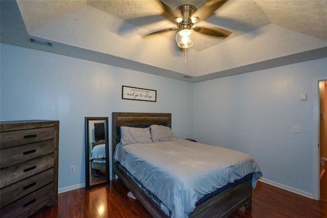 bedroom with dark wood-type flooring, vaulted ceiling, and ceiling fan