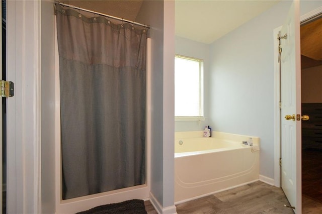 bathroom with plus walk in shower and hardwood / wood-style floors