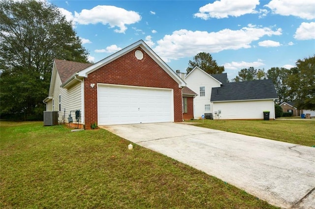 view of front of property with a garage, cooling unit, and a front lawn