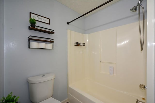 bathroom with bathing tub / shower combination and toilet