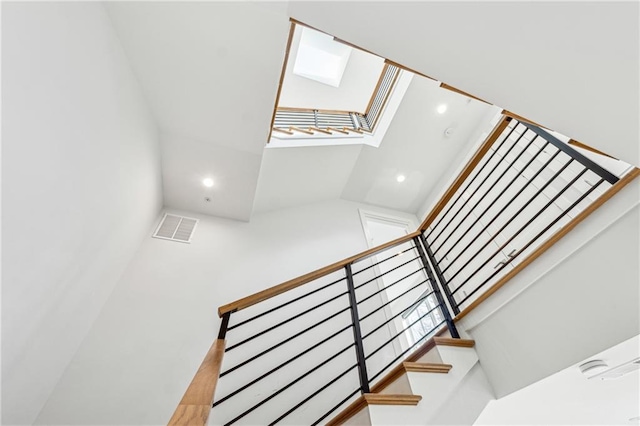 stairs with a skylight, visible vents, and recessed lighting