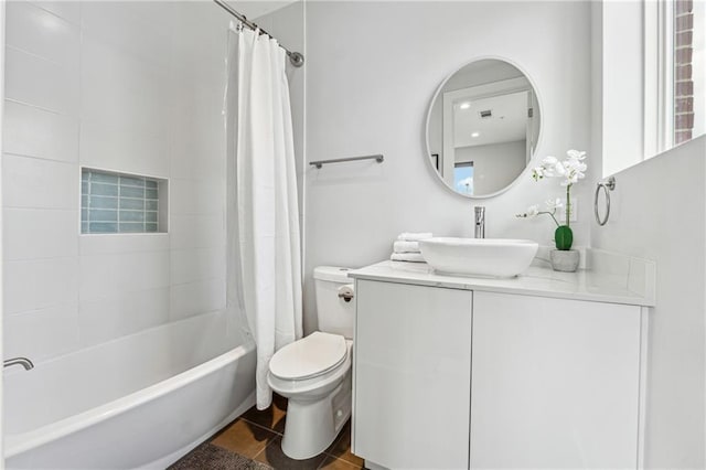 bathroom featuring vanity, shower / bath combination with curtain, toilet, and tile patterned floors