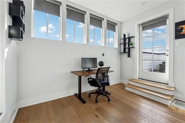 home office with wood finished floors and baseboards