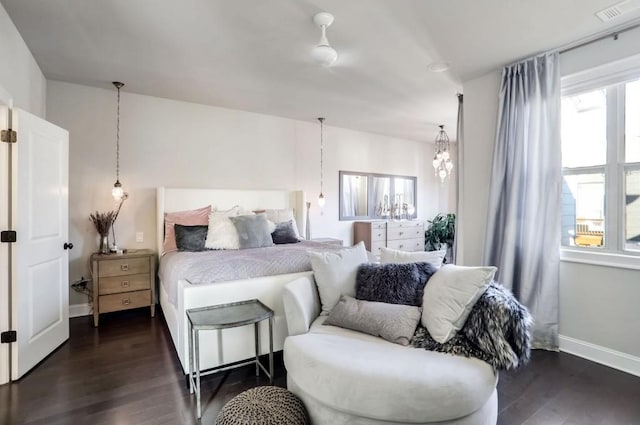 bedroom featuring dark hardwood / wood-style flooring and multiple windows