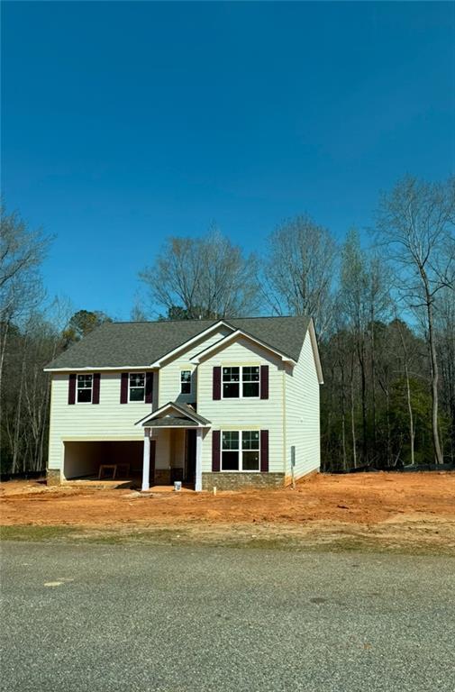1091 Boulder Dr, Gray, GA 31032 - view of front of house featuring an attached garage, driveway, a front yard, and a shingled roof