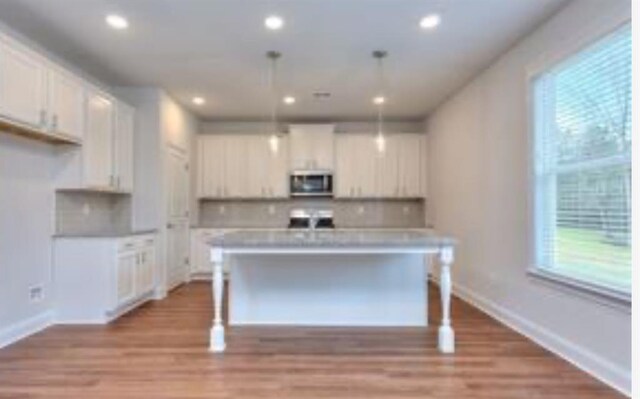 1091 Boulder Dr, Gray, GA 31032 - unfurnished living room featuring ceiling fan, baseboards, a glass covered fireplace, and wood finished floors