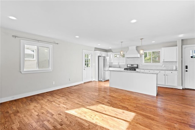 2677 Tilson Rd, Decatur, GA 30032 - kitchen with stainless steel appliances, custom range hood, white cabinets, decorative backsplash, and a kitchen island