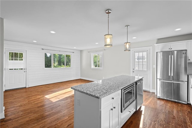 2677 Tilson Rd, Decatur, GA 30032 - kitchen featuring appliances with stainless steel finishes, light stone countertops, recessed lighting, white cabinetry, and dark wood-type flooring