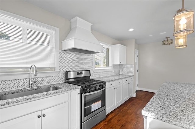 2677 Tilson Rd, Decatur, GA 30032 - kitchen with stainless steel gas stove, custom range hood, a sink, backsplash, and dark wood-style floors