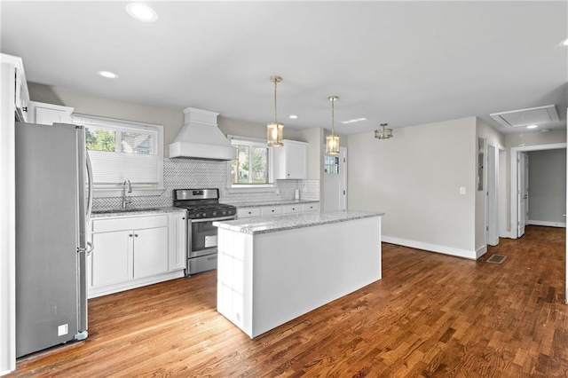 2677 Tilson Rd, Decatur, GA 30032 - kitchen with premium range hood, appliances with stainless steel finishes, a sink, a kitchen island, and white cabinetry