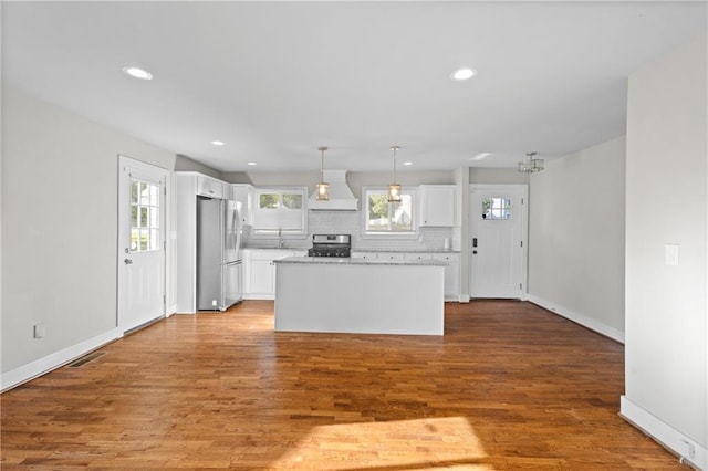 2677 Tilson Rd, Decatur, GA 30032 - kitchen with appliances with stainless steel finishes, premium range hood, white cabinets, plenty of natural light, and recessed lighting