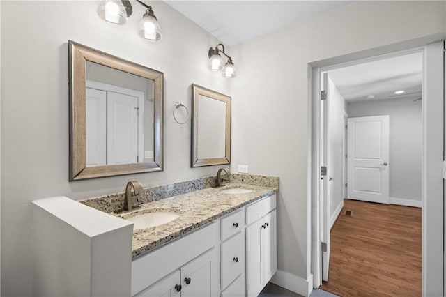 2677 Tilson Rd, Decatur, GA 30032 - bathroom with baseboards, wood finished floors, and double vanity