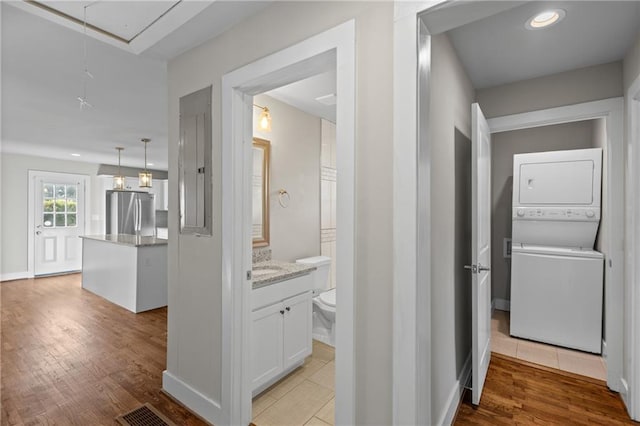 2677 Tilson Rd, Decatur, GA 30032 - corridor featuring attic access, stacked washing machine and dryer, light wood-type flooring, recessed lighting, and baseboards