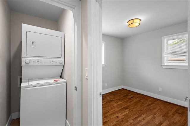 2677 Tilson Rd, Decatur, GA 30032 - washroom with stacked washer and clothes dryer, wood finished floors, and baseboards