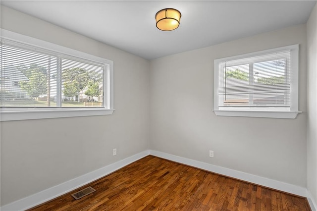 2677 Tilson Rd, Decatur, GA 30032 - empty room with plenty of natural light, baseboards, and wood finished floors