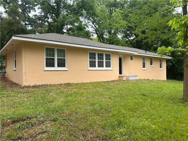 view of front of property featuring stucco siding and a front lawn