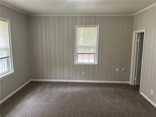 carpeted spare room with ornamental molding and baseboards