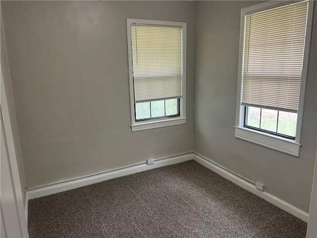unfurnished room featuring carpet floors, healthy amount of natural light, and baseboards