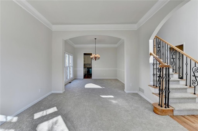 interior space featuring an inviting chandelier, carpet, and crown molding