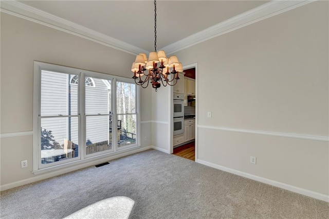 carpeted empty room with crown molding and a notable chandelier