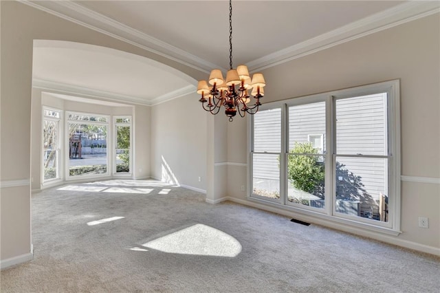 carpeted empty room with ornamental molding and a chandelier