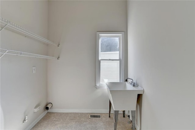 laundry area with plenty of natural light