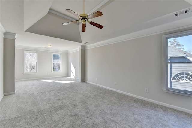 spare room with ceiling fan, light colored carpet, a raised ceiling, and crown molding