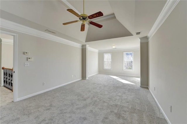 spare room with ceiling fan, crown molding, light carpet, and a tray ceiling