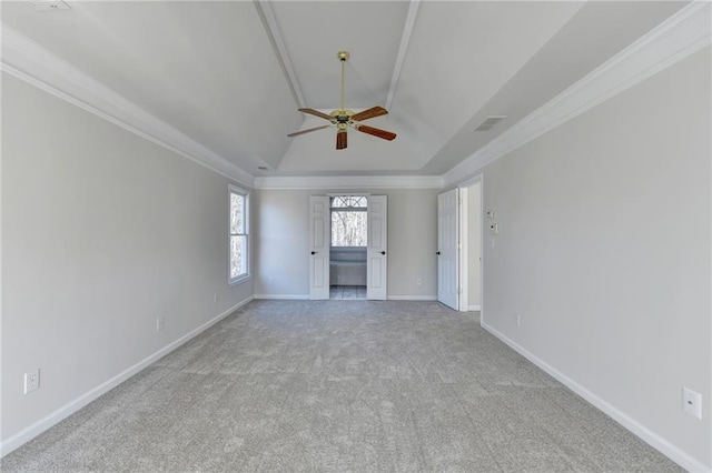 carpeted empty room with ceiling fan, ornamental molding, and lofted ceiling