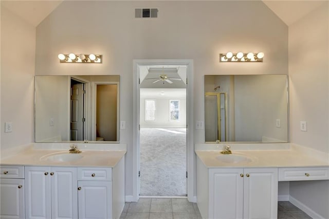 bathroom with lofted ceiling, vanity, ceiling fan, and a shower with shower door