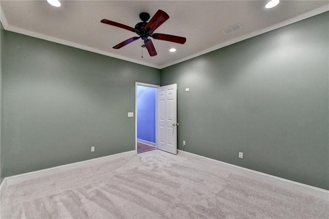 unfurnished room featuring light colored carpet, ceiling fan, and crown molding