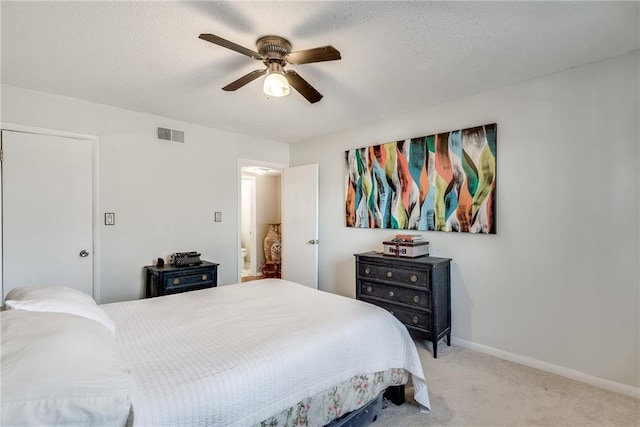 bedroom with light carpet, baseboards, visible vents, a ceiling fan, and a textured ceiling