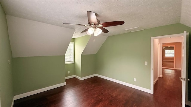 446 Russell Cemetery Rd, Winder, GA 30680 - additional living space with healthy amount of natural light, wood finished floors, lofted ceiling, ceiling fan, and a textured ceiling