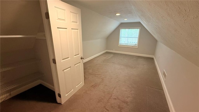 446 Russell Cemetery Rd, Winder, GA 30680 - bonus room with baseboards, carpet floors, vaulted ceiling, and a textured ceiling