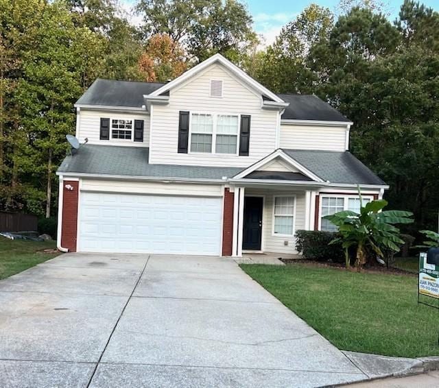 view of front of property featuring a front yard and a garage