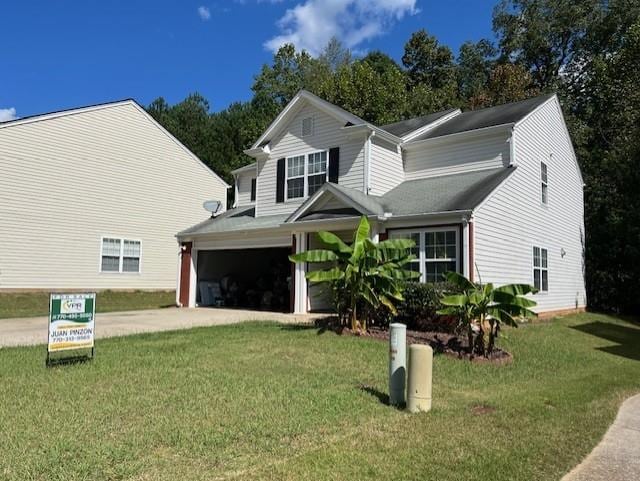 view of front facade with a front yard and a garage