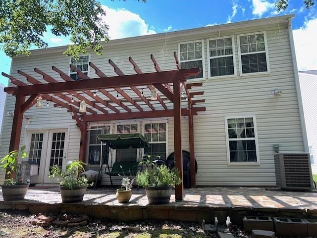 back of property with a pergola, a patio, and central air condition unit