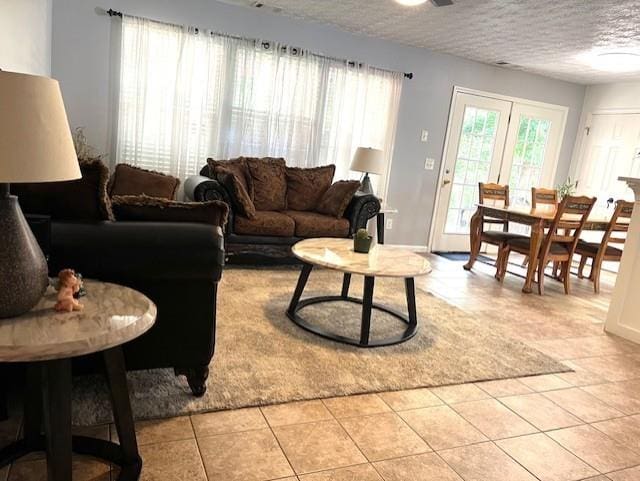 tiled living room with a textured ceiling