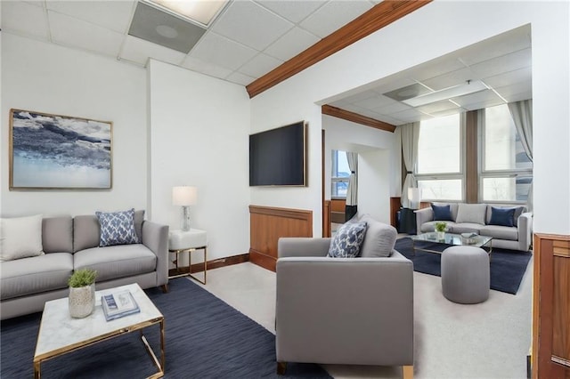 living room with ornamental molding and a drop ceiling