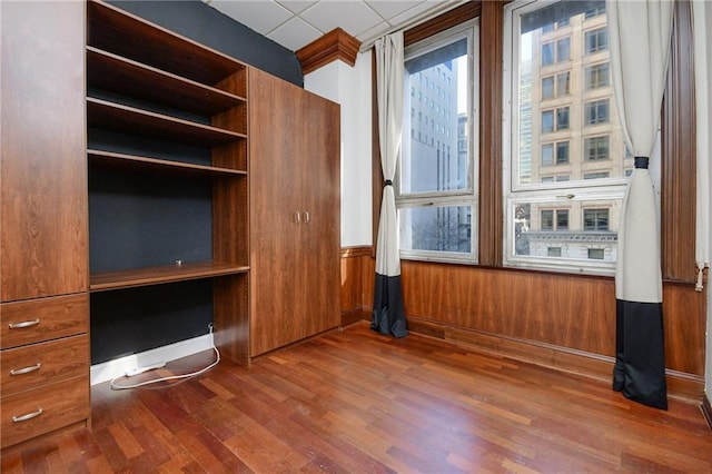 interior space with dark hardwood / wood-style flooring and a paneled ceiling